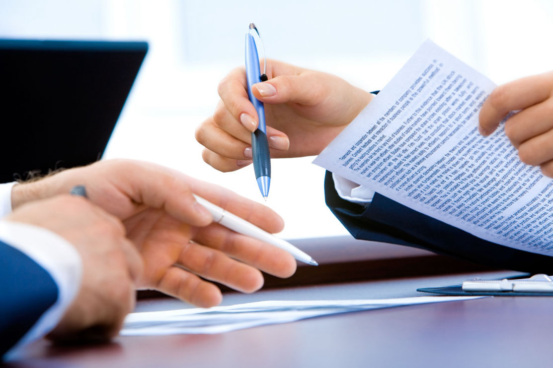 Hands reviewing a financial document